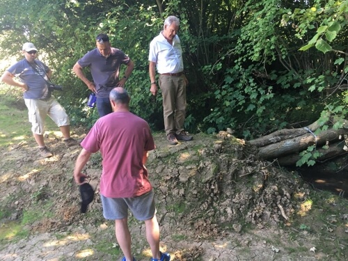 In late June, 11 members of the Environment Agency, including senior directors and managers, mainly from London visited Shipston-on-Stour and toured the extensive River Stour catchment where flood intervention measures have been installed during 2017 - 2018. They were invited by members of the Shipston Area Flood Action Group (SAFAG) to view some of the 175 flood intervention measures which have been installed on the Knee Brook (the main watercourse in the area) and its tributaries. The Environment Agency has been very supportive of SAFAG over the last few years as they view the Group as leaders and national pathfinders in community led natural flood management (NFM) projects across the UK. The 175 NFM interventions, such as woody dams, ponds and bunds etc, are designed to 'slow the flow' of the watercourses typically on farmland in the upper reaches during spate conditions. It is intended that this holding back and slowing of the flood waters will reduce the risk of flooding to homes and businesses in Shipston and numerous other villages in the local area. Over a working lunch, SAFAG members delivered a video presentation of the 2007 floods which emphasised the extent of the flooding problem in the area. Also during the visit the EA members were given the opportunity to assist in building 2 woody dams to better understand the challenges and issues involved. The visit was a great success and assisted in enhancing partnership working with the Environment Agency as SAFAG bid for future funding. Any further grants obtained will be used to install several hundred more NFM interventions on the other 2 watercourses in the Stour catchment, thereby reducing the risk of flooding to properties even further.