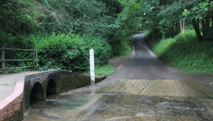 An image of Traitor's food at normal levels. The tunnels under the walk bridge are clear and you can see the concrete floor to the brook which doubles as the road.