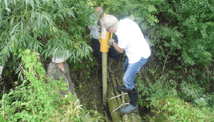 maintaining a leaky wooden dam in Ditchford